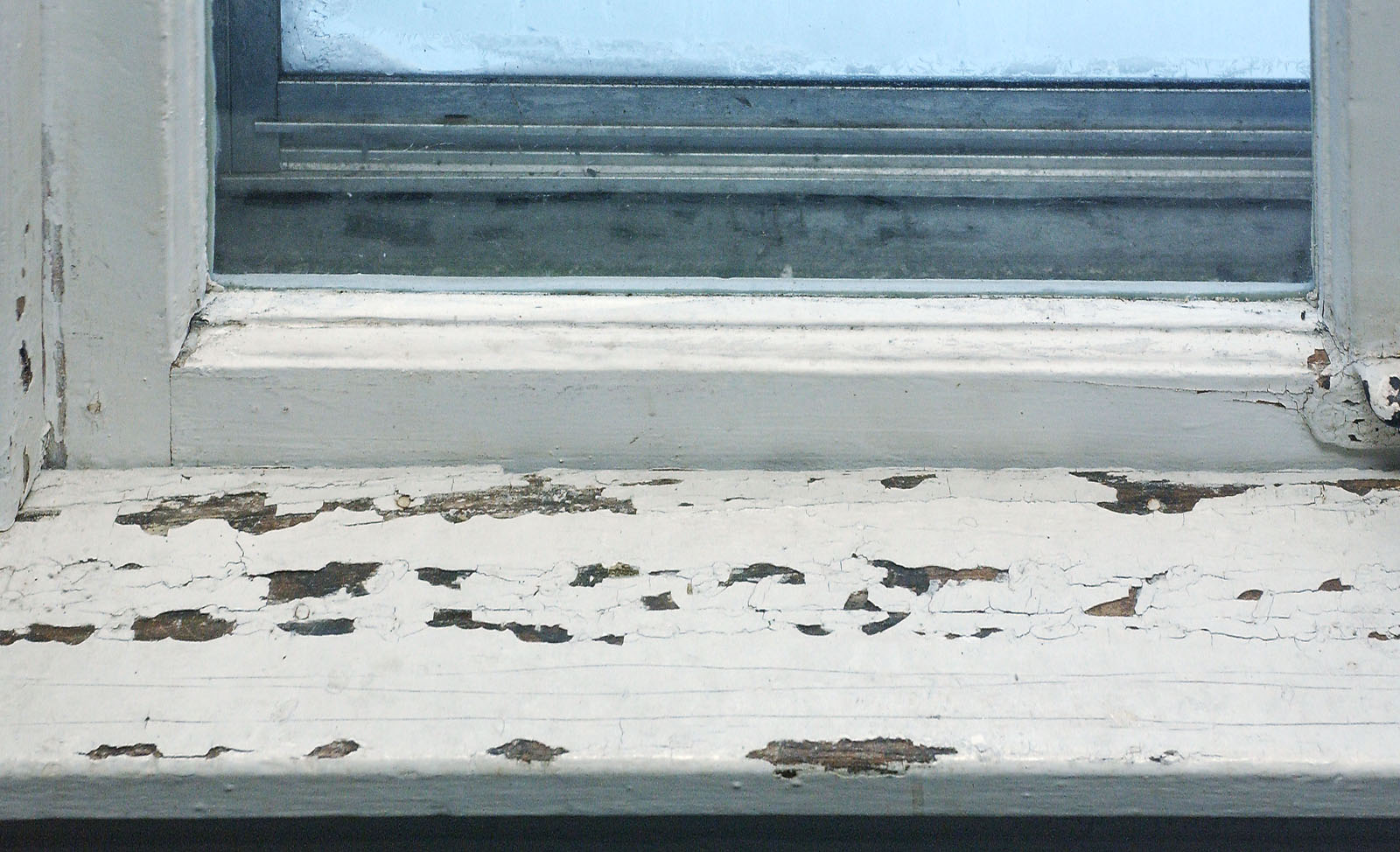 chipped lead paint in a window
